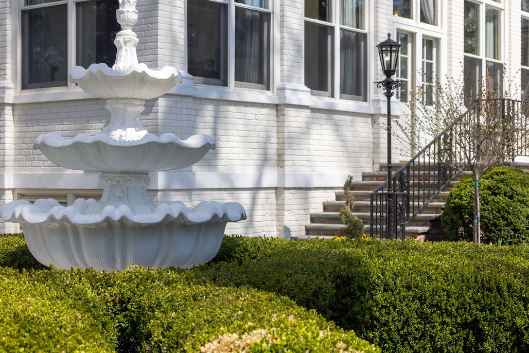 The fountain in the Marine Corps Family Garden at Marine Barracks Washington, D.C., photographed March 25, 2025. The Marine Corps Family Garden is located in the Home of the Commandants' backyard, serving as a peaceful space dedicated to Marine families. Used for receptions, small ceremonies, and quiet reflection, the garden offers a contrast to the formal discipline of the parade deck. It features plaques and memorials honoring Marine families and serves as a gathering place for dignitaries and visitors. The garden stands as a tribute to the resilience and support of Marine families, reinforcing the unity of the Marine Corps community. (U.S. Marine Corps photo by Lance Cpl. Christopher Prelle)