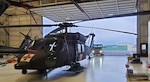 An Alaska Army National Guard HH-60M Black Hawk medical evacuation helicopter is pulled out of hangar six at Bryan Army Airfield on Joint Base Elmendorf-Richardson as part of a routine training mission March 26, 2025. Soldiers with G Company, 2-211th General Support Aviation Battalion, rescued three people from the wreckage of a crashed PA-12 Super Cruiser partially submerged in glacial ice March 24, 2025.