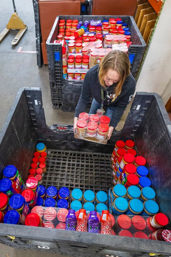 Kathi Morgan, calibration coordinator, Shop 99, Temporary Services, collects jars of donated peanut butter, Feb. 19, 2025, during her lunch at Puget Sound Naval Shipyard & Intermediate Maintenance Facility in Bremerton, Washington. (U.S. Navy photo by Wendy Hallmark)