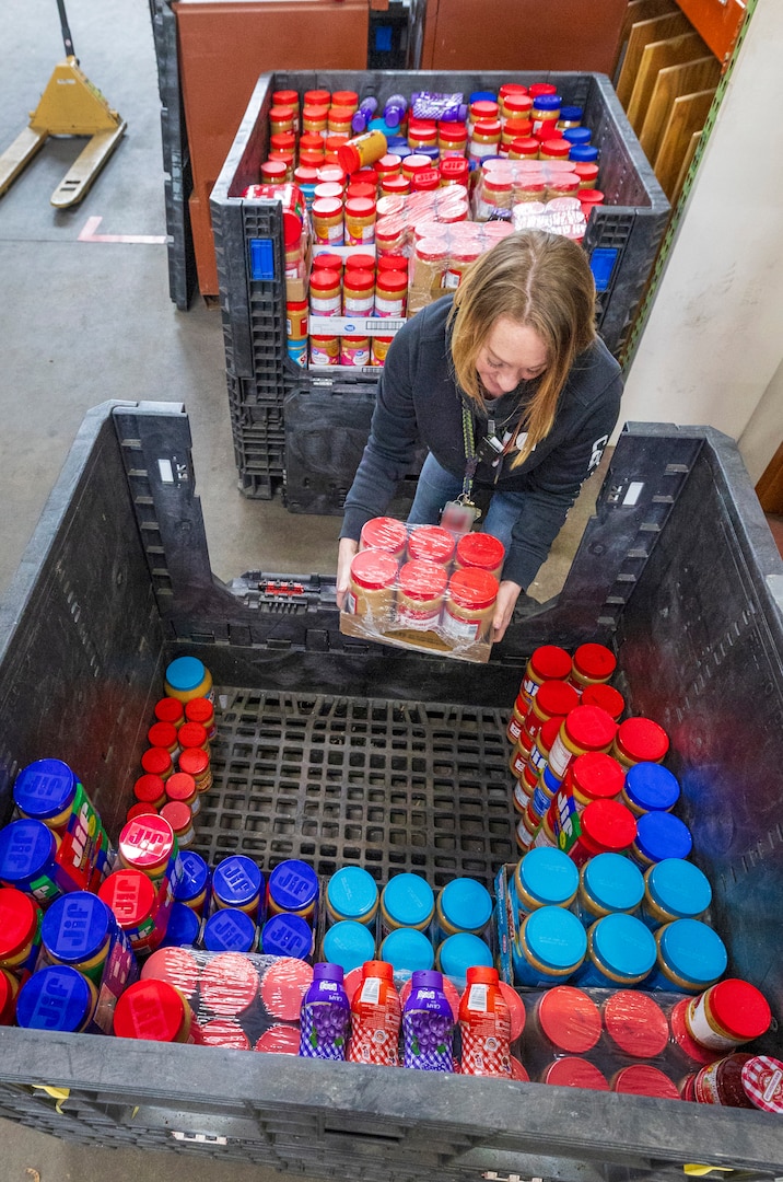 Kathi Morgan, calibration coordinator, Shop 99, Temporary Services, collects jars of donated peanut butter, Feb. 19, 2025, during her lunch at Puget Sound Naval Shipyard & Intermediate Maintenance Facility in Bremerton, Washington. (U.S. Navy photo by Wendy Hallmark)