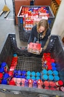 Kathi Morgan, calibration coordinator, Shop 99, Temporary Services, collects jars of donated peanut butter, Feb. 19, 2025, during her lunch at Puget Sound Naval Shipyard & Intermediate Maintenance Facility in Bremerton, Washington. (U.S. Navy photo by Wendy Hallmark)