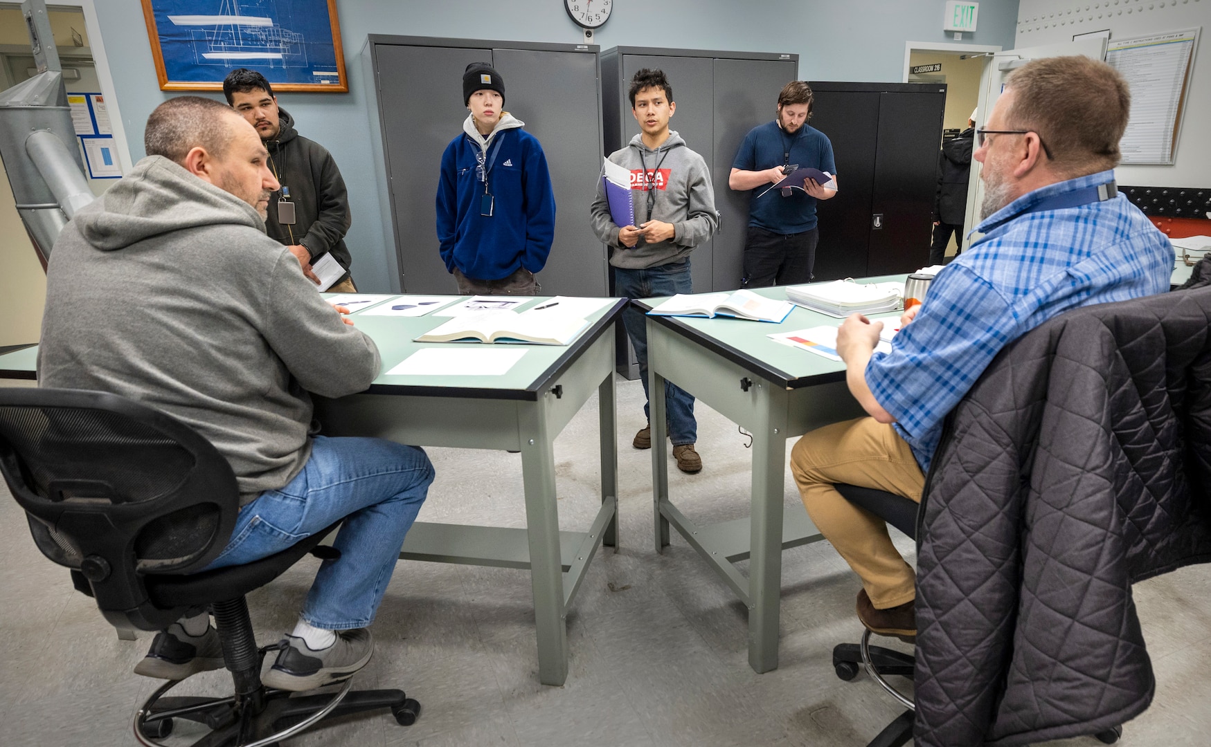 Jamie Slaughter, instructor, Shop 17, SheetMetal, and Tony Brown, apprentice manager, Shop 11/17, Metal Forge and SheetMetal, talk with command employees about the Puget Sound Naval Shipyard & Intermediate Maintenance Facility Apprentice Program, in Bremerton, Washington. (U.S. Navy photo by Wendy Hallmark)