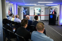 CJ DuRain, 309th Software Engineering Group director of management, speaks during a ribbon cutting ceremony for two new software training and onboarding facilities at Hill Air Force Base, Utah, March 26, 2025. The Launch Pad facility will help new hires awaiting security clearances enhance their skills and leadership, while SWEG U will provide ongoing training for 309th SWEG employees and software engineering groups from other bases. (U.S. Air Force photo by R. Nial Bradshaw)