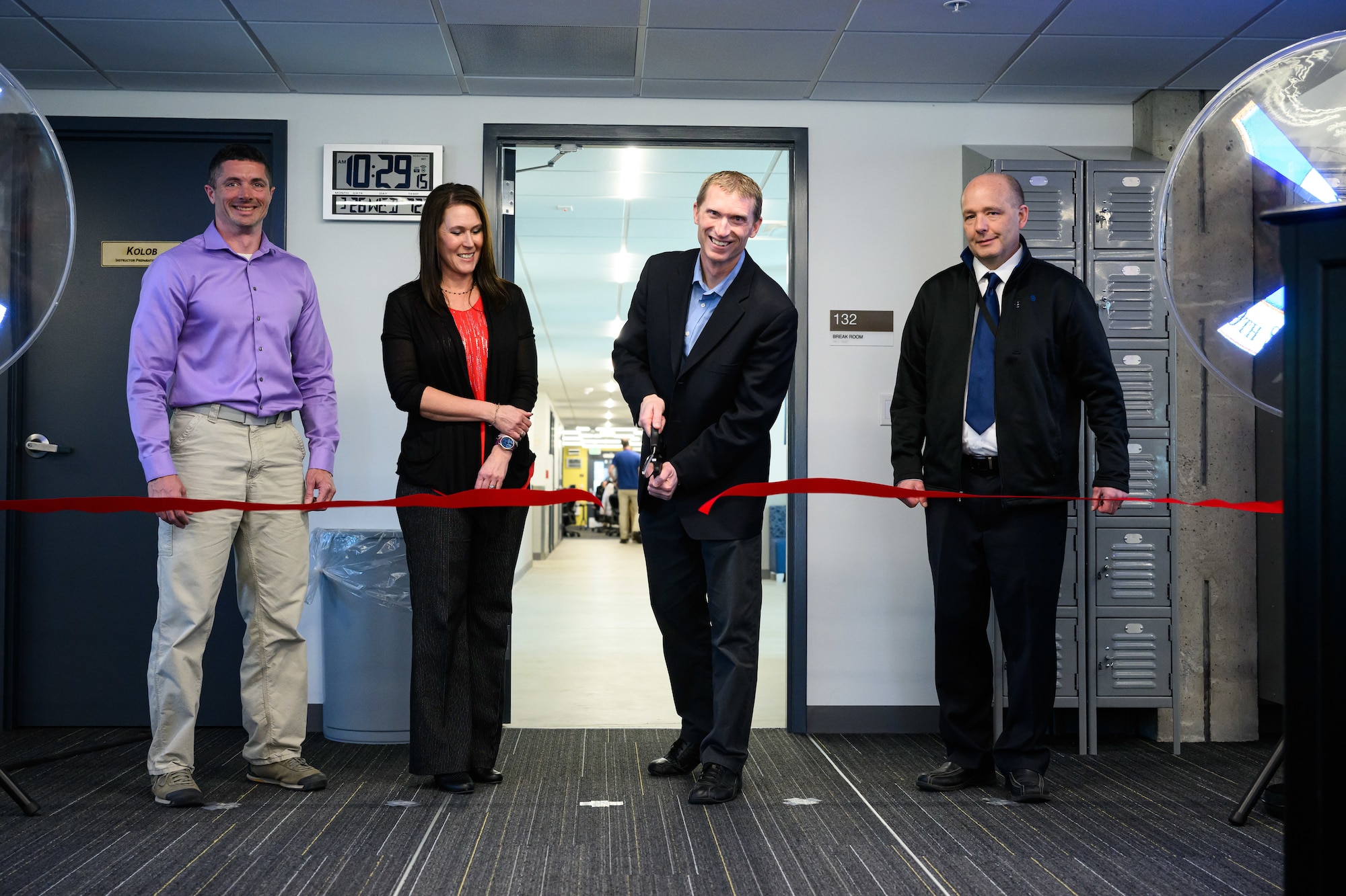 Chad Harper, 309th Software Engineering Group deputy director, cuts a ribbon during a ceremony marking the opening of two new software training and onboarding facilities at Hill Air Force Base, Utah, March 26, 2025. The Launch Pad facility will help new hires awaiting security clearances enhance their skills and leadership, while SWEG U will provide ongoing training for 309th SWEG employees and software engineering groups from other bases. (U.S. Air Force photo by R. Nial Bradshaw)