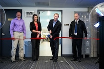 Chad Harper, 309th Software Engineering Group deputy director, cuts a ribbon during a ceremony marking the opening of two new software training and onboarding facilities at Hill Air Force Base, Utah, March 26, 2025. The Launch Pad facility will help new hires awaiting security clearances enhance their skills and leadership, while SWEG U will provide ongoing training for 309th SWEG employees and software engineering groups from other bases. (U.S. Air Force photo by R. Nial Bradshaw)