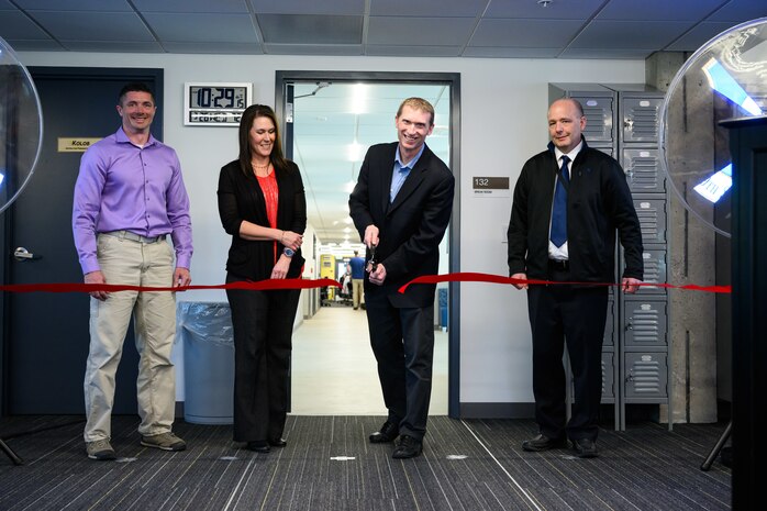 Chad Harper, 309th Software Engineering Group deputy director, cuts a ribbon during a ceremony marking the opening of two new software training and onboarding facilities at Hill Air Force Base, Utah, March 26, 2025. The Launch Pad facility will help new hires awaiting security clearances enhance their skills and leadership, while SWEG U will provide ongoing training for 309th SWEG employees and software engineering groups from other bases. (U.S. Air Force photo by R. Nial Bradshaw)