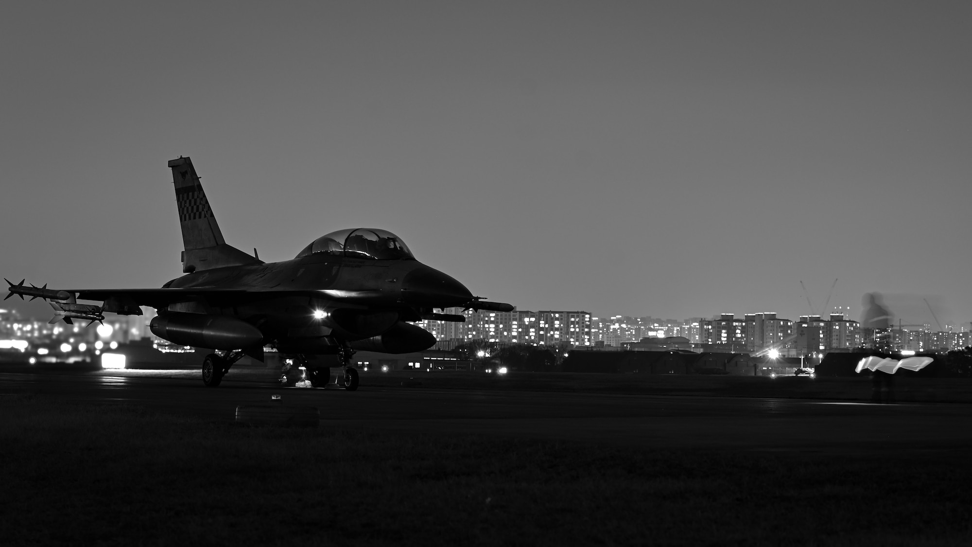 A U.S. Air Force F-16 Fighting Falcon undergoes a night inspection before refueling during Freedom Shield 25 at Suwon Republic of Korea Air Base, March 12, 2025. Throughout FS25, the 51st Fighter Wing maximized sortie generation, conducting numerous hot-pit refueling daily, while ground teams applied ACE principles across diverse mission sets–from medical to unexploded ordnance response. (U.S. Air Force photo by Senior Airman Sabrina Fuller-Judd) (This image was created in color and changed to black-and-white.)