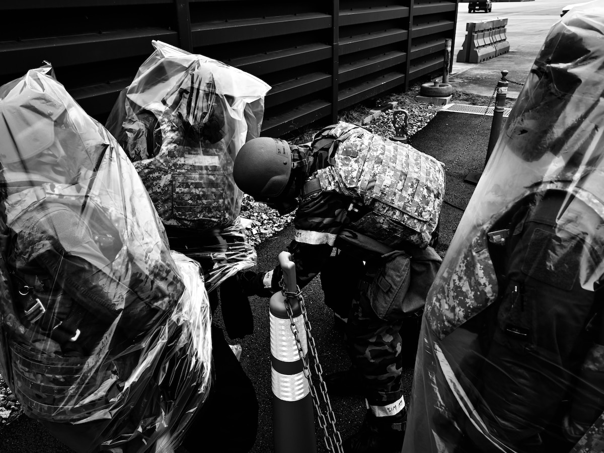 U.S. Air Force F-16 Fighting Falcon pilots receive gear while in MOPP 4 during a simulated missile attack scenario during Freedom Shield 25 at Suwon Republic of Korea Air Base, March 12, 2025. Much like attack signal warnings, MOPP levels adjust personal protection against chemical, biological, radiological, nuclear, and explosive threats.  In MOPP 4, personnel wear the over-garment, over-boots, protective mask, and gloves for maximum protection. (U.S. Air Force photo by Senior Airman Sabrina Fuller-Judd)