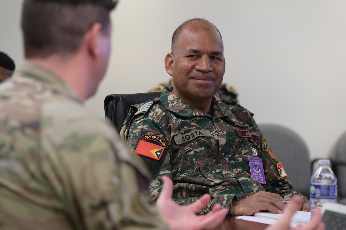 Foreign national visitor from Falintil - Forcas de Defesa de Timor-Leste speaks to a U.S. Air Force Airman.