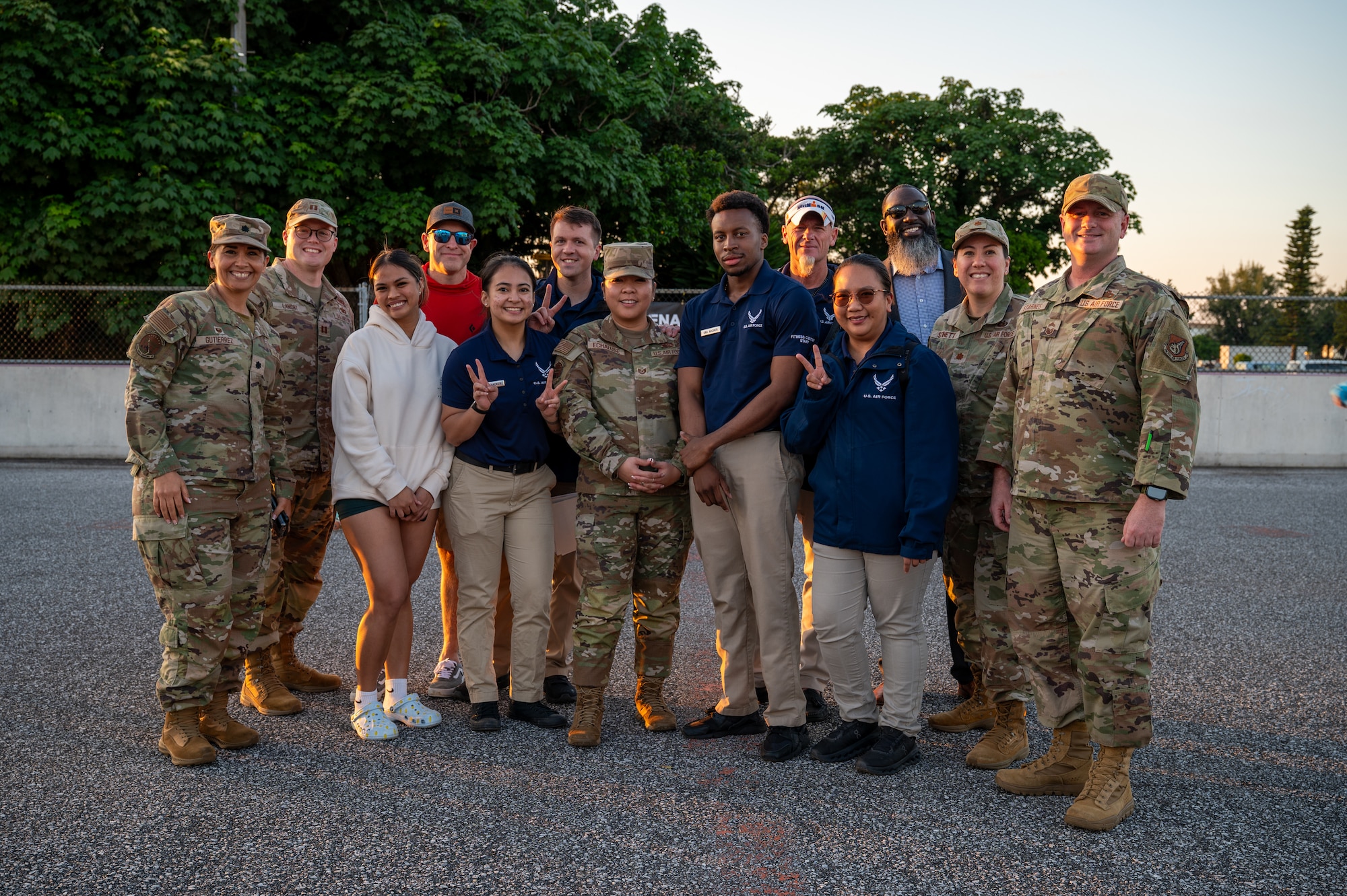 Civilians and service members pose for group photo.