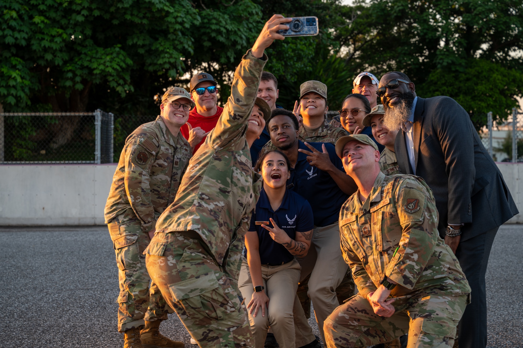Civilians and service members taking group photo.