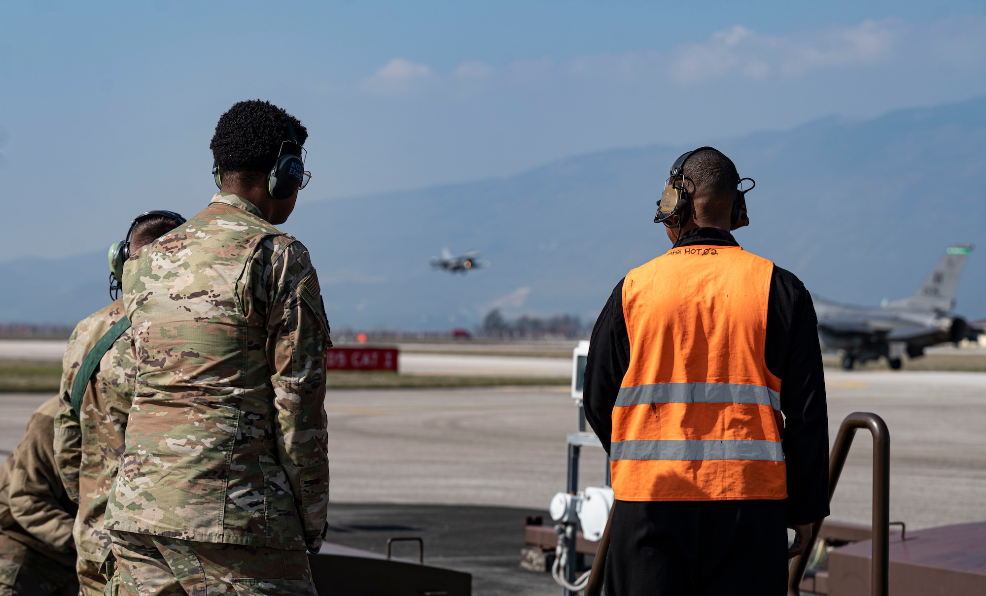 people watching plane land