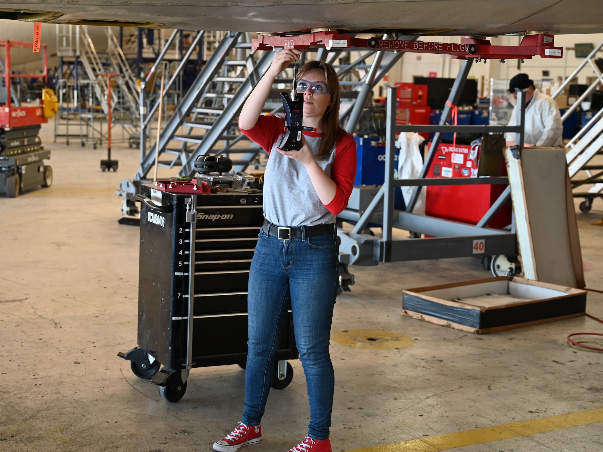 A woman holding a scanning tool.