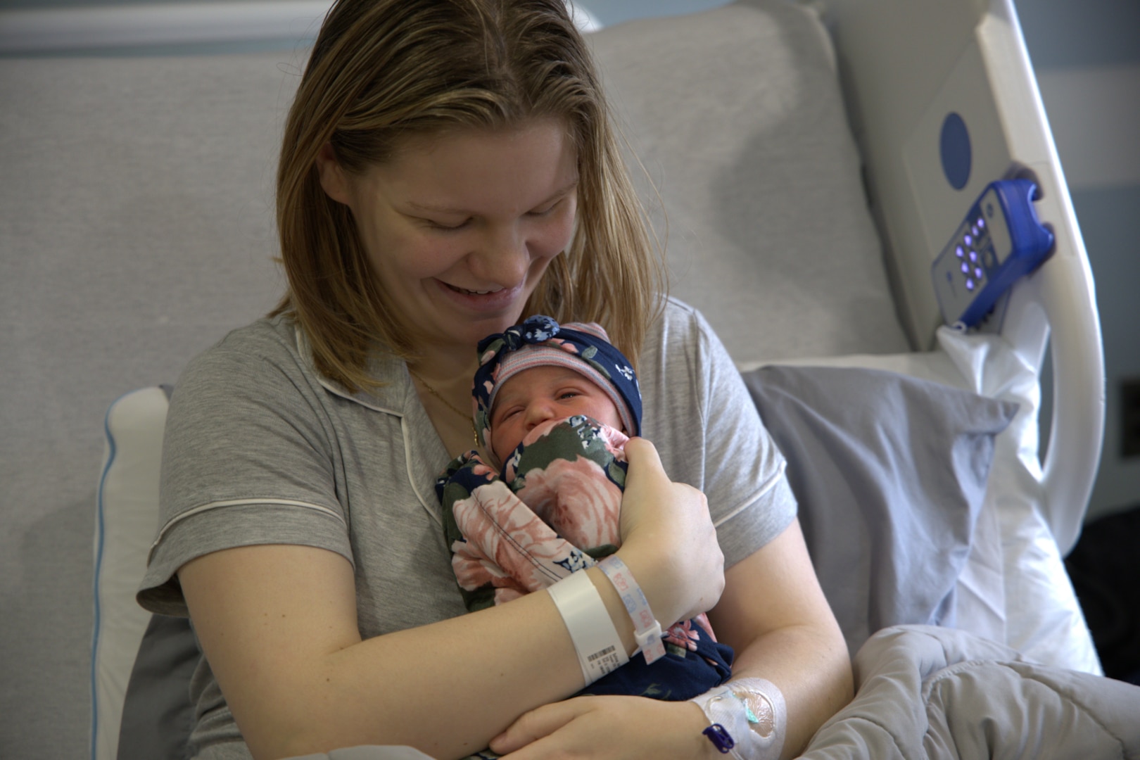 Woman holds her baby.