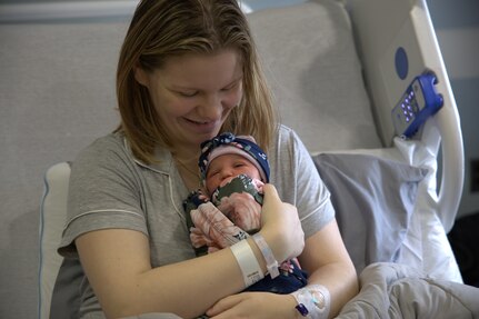Woman holds her baby.