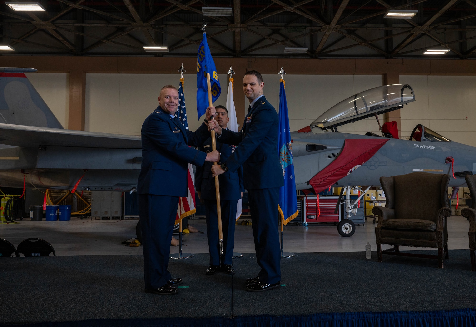 Service members hold flag.