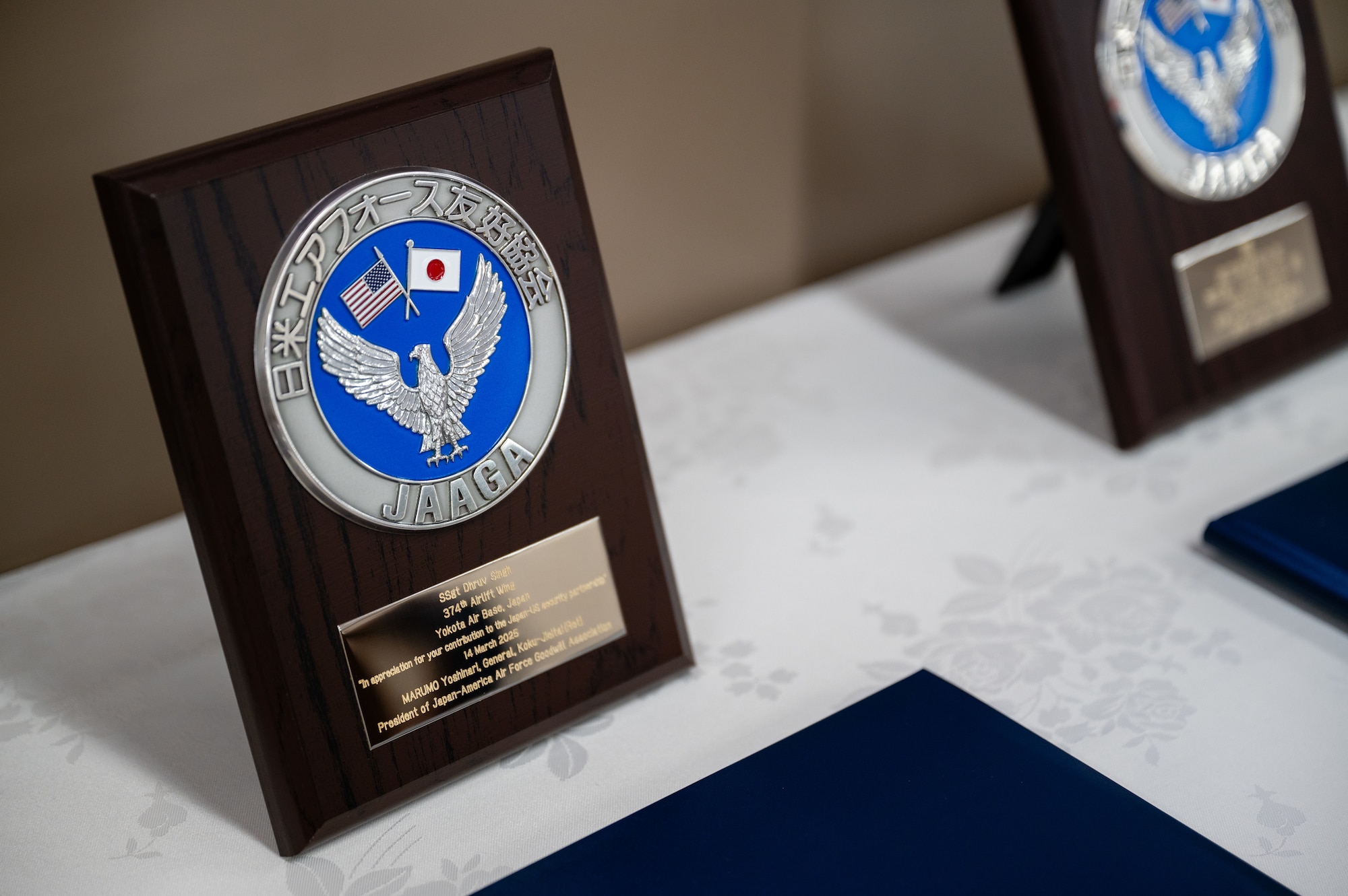 A plaque rests on a table during the Japan-America Air Force Goodwill Association Award Ceremony at Yokota Air Base, Japan.