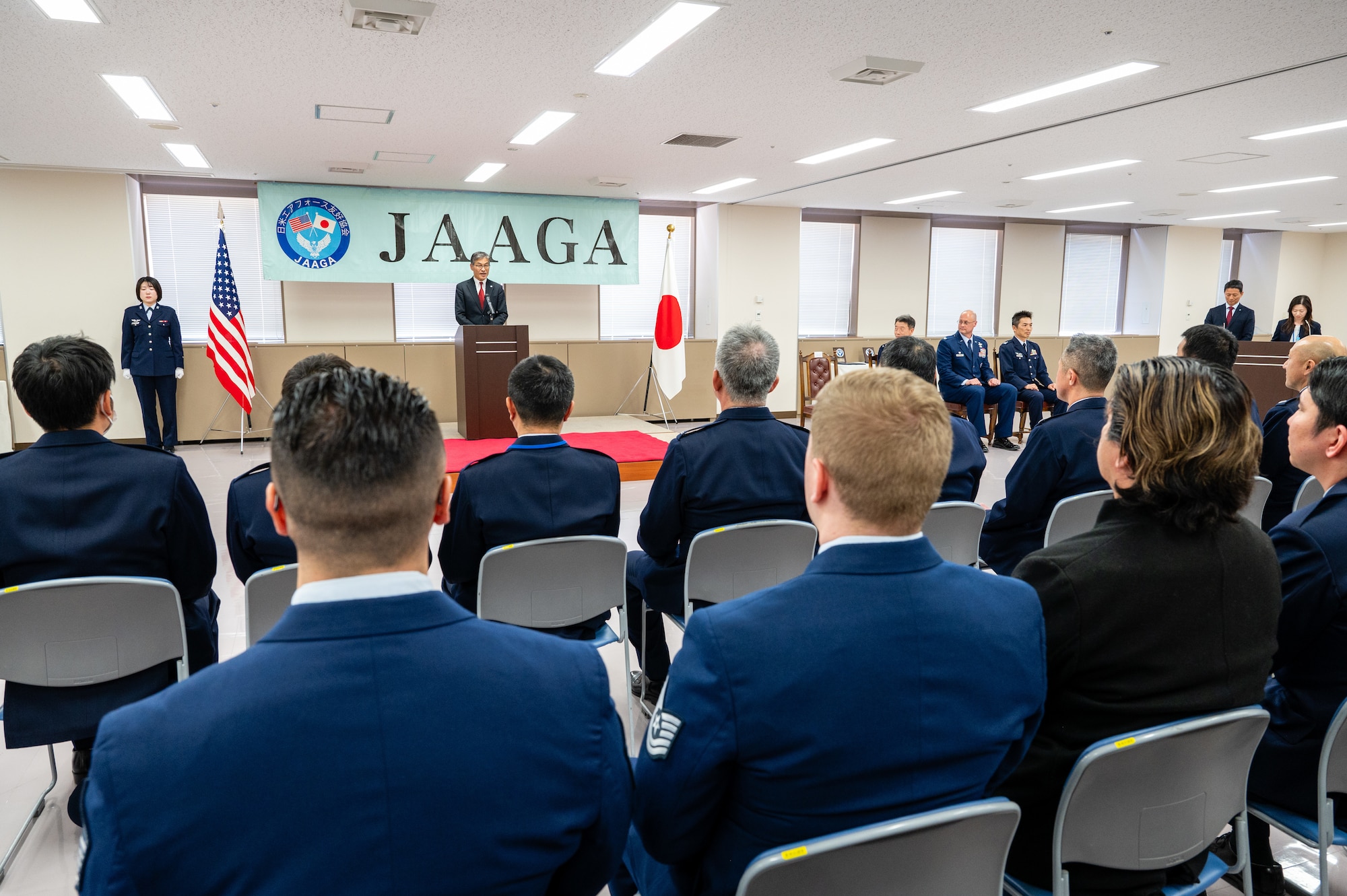 Members of the U.S. Air Force and Japan Air Self-Defense Force listen to opening remarks during the Japan-America Air Force Goodwill Association Award Ceremony at Yokota Air Base, Japan.