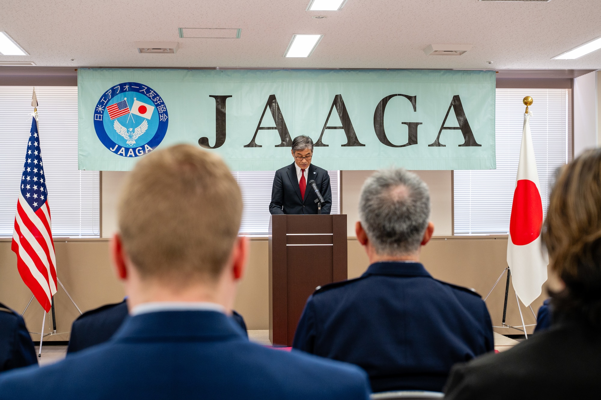 Yoshinari Marumo, president of the Japan-America Air Force Goodwill Association, delivers opening remarks during the JAAGA Award Ceremony at Yokota Air Base, Japan.