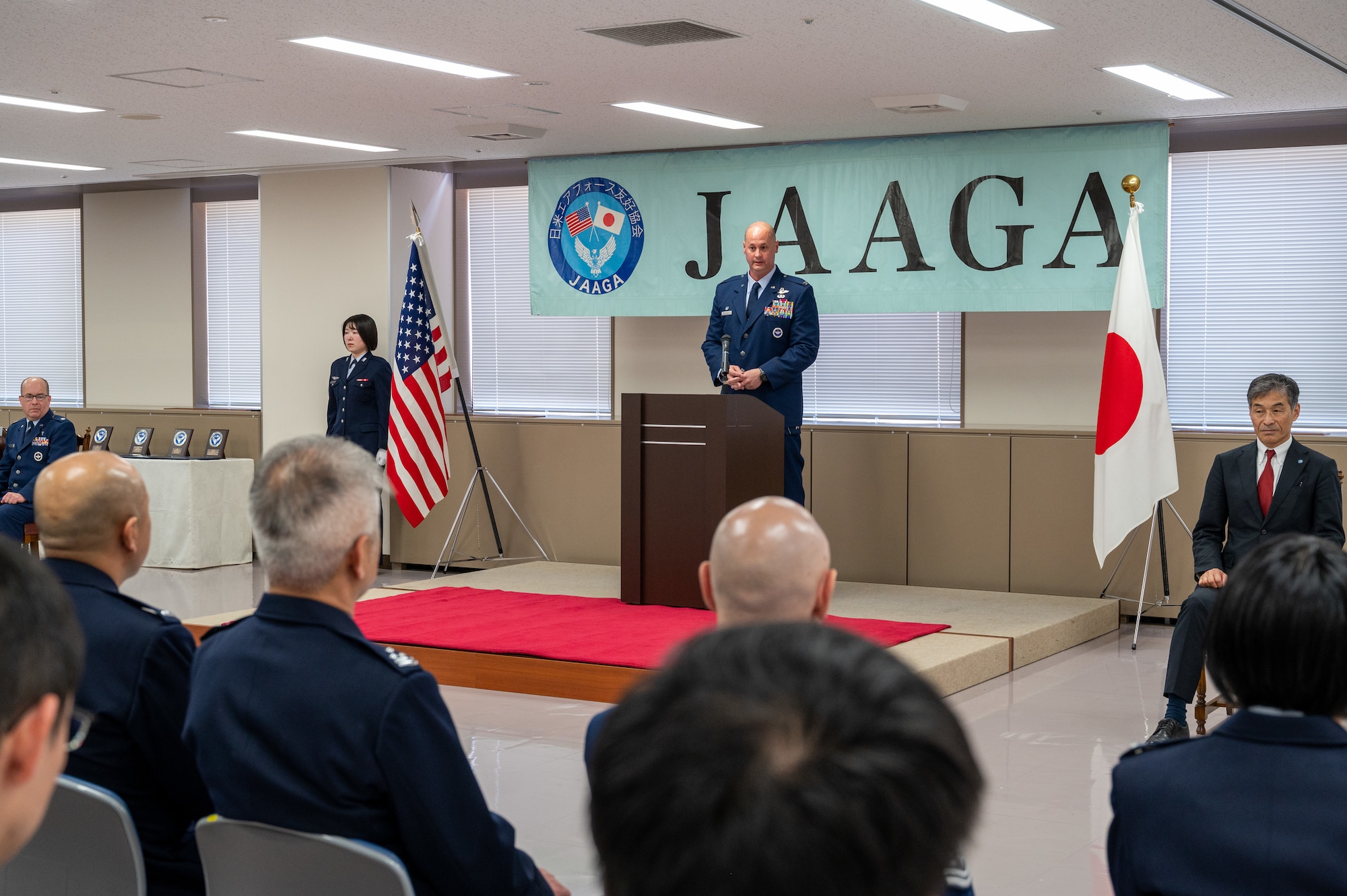 U.S. Air Force Col. Richard McElhaney, 374th Airlift Wing commander, delivers remarks during the Japan-America Air Force Goodwill Association Award Ceremony at Yokota Air Base, Japan.