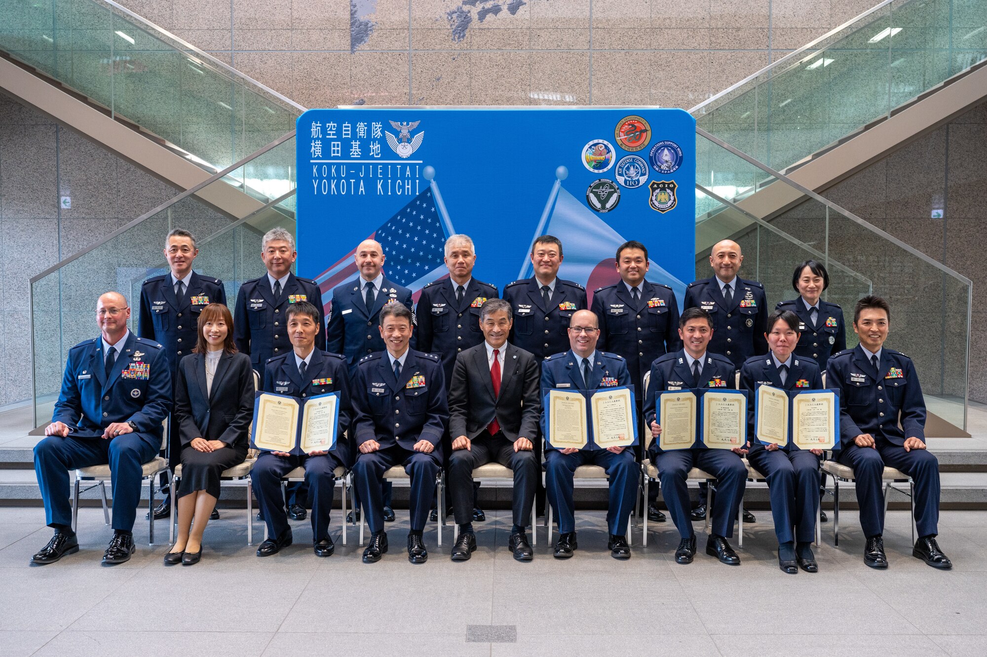Members of the U.S. Air Force, Japan Air Self-Defense Force, and Japan-America Air Force Goodwill Association pose for a photo following the JAAGA Award Ceremony at Yokota Air Base, Japan.