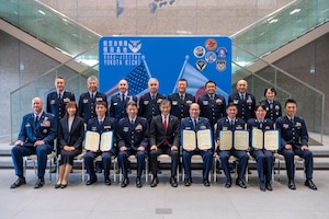 Members of the U.S. Air Force, Japan Air Self-Defense Force, and Japan-America Air Force Goodwill Association pose for a photo following the JAAGA Award Ceremony at Yokota Air Base, Japan.