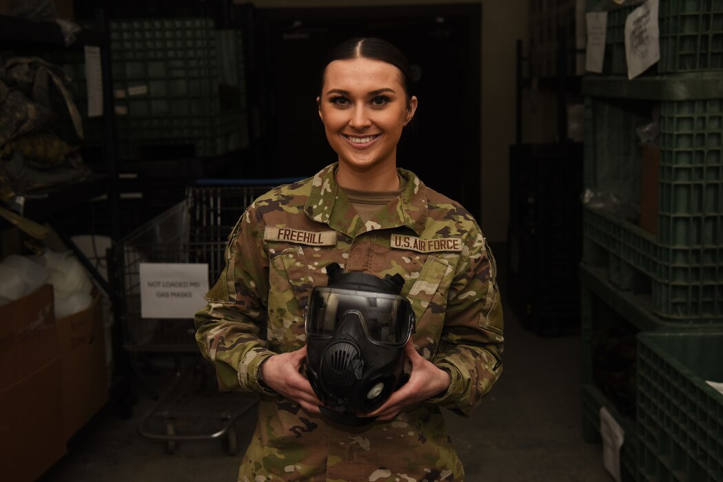 U.S. Air Force Airman 1st Class Carly Freehill, 51st Logistics Readiness Squadron, individual protective equipment journeyman, poses with a gas mask at Osan Air Base, Republic of Korea, 25 March 2025.