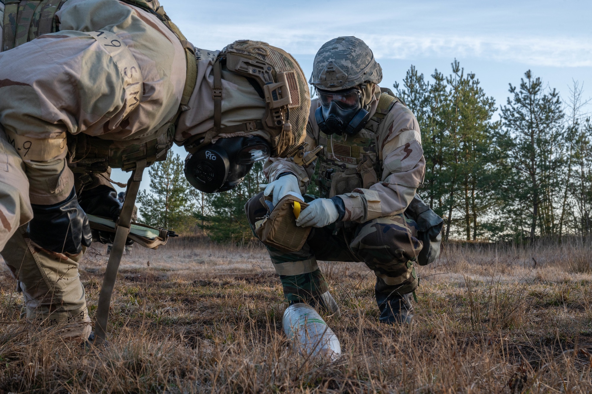 Two people inspect an unexploded ordnance