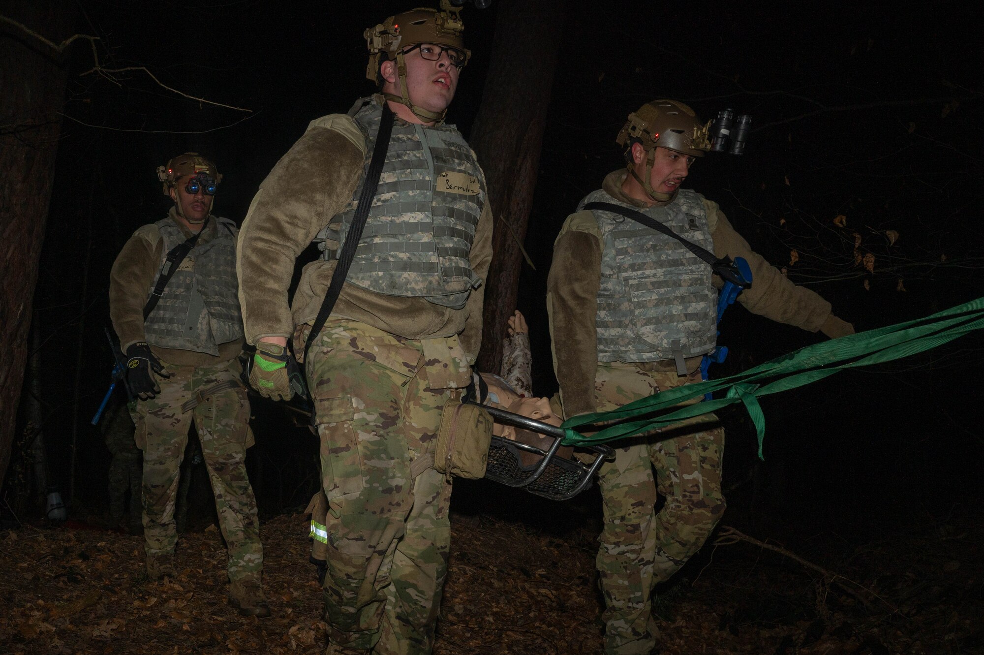 Firemen carry a dummy on a litter