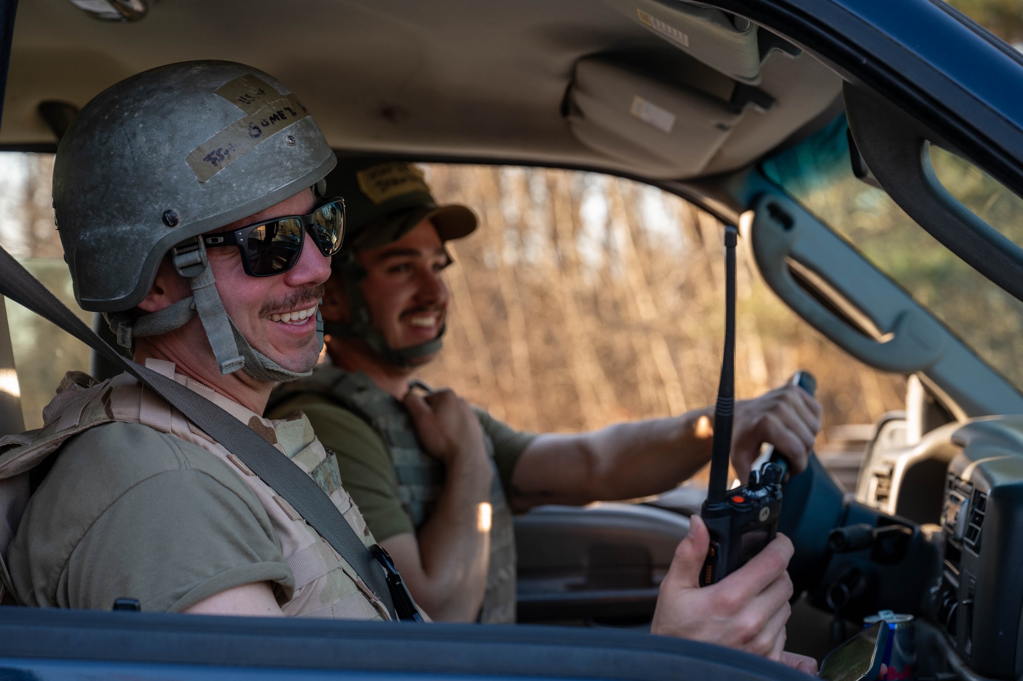 Two men use a radio to call in a unexploded ordnance
