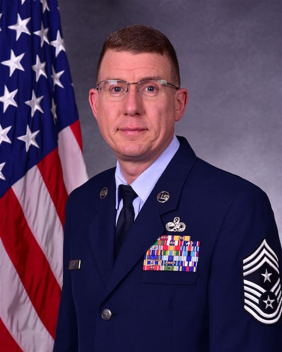 Man in uniform poses for photo