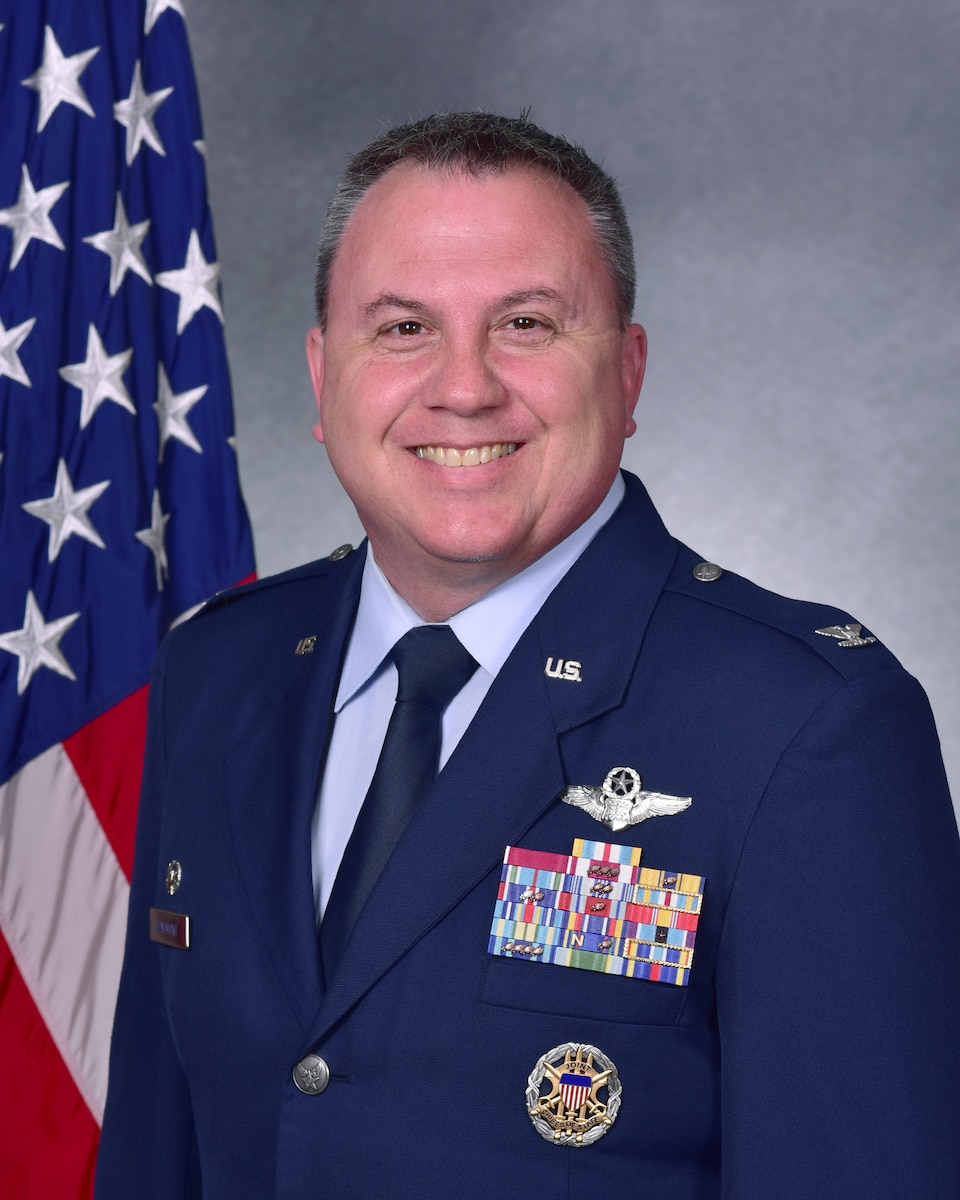 Man in uniform poses for photo