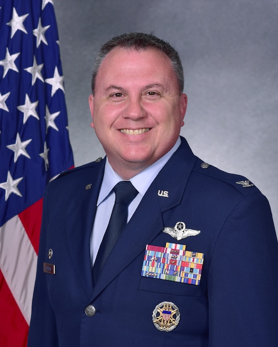 Man in uniform poses for photo