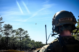 U.S. Marine Corps Staff Sgt. Hayden Sohmer, 25th Marine Regiment, 4th Marine Division, Marine Forces Reserve, joint terminal attack controller instructor, observes an A-10 Thunderbolt II during a close air support exercise at Warren Grove Training Range, N.J., March 11, 2025. JTACs assigned to the 25th Marine Regiment conducted a training for recertification, which included both live target coordinated air and artillery strikes. A JTAC is a qualified service member who directs the action of military assets engaged in close land and air support during offensive operations from a forward position. (U.S. Air Force photo by Senior Airman Matt Porter)