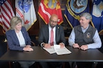 The Defense Logistics Agency’s Deputy Director of Logistics Operations Kristin French, left, the Veteran Health Administration’s Deputy Assistant Under Secretary for Health for Support Ronald Miller, center, and DLA’s Deputy Chief Financial Officer Shawn Lennon, right, sign a 10-year, $3.6 billion Level 2 interagency agreement March 12, 2025, at the McNamara Headquarters Complex in Fort Belvoir, Virginia.