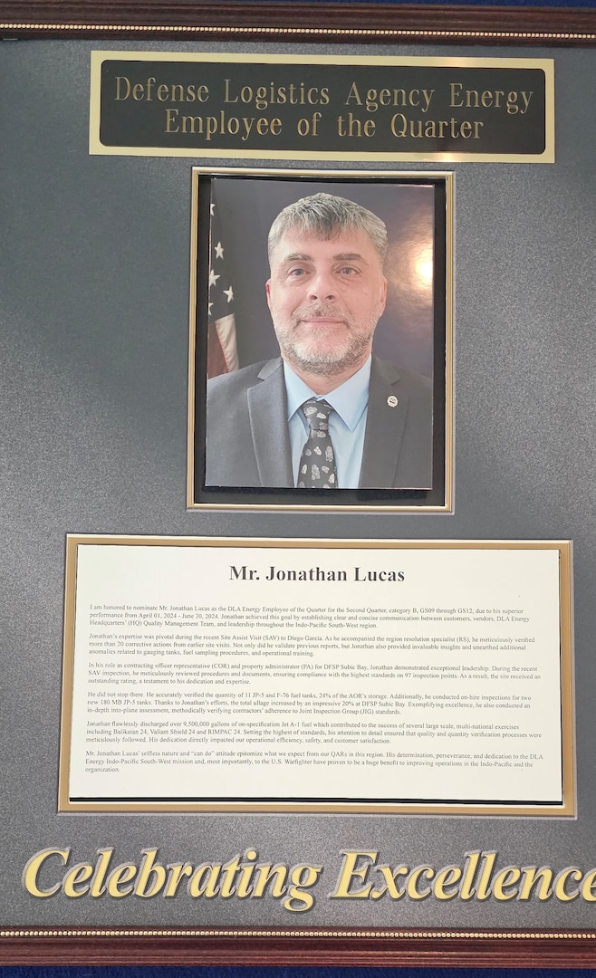 Hallway plaque celebrating Jonathan Lucas as DLA Energy's Employee of the Quarter