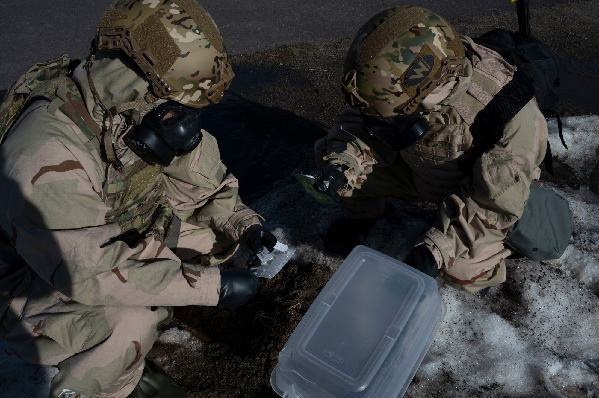 U.S. Air Force Airman 1st Class Michael Antonellis and Airman 1st Class Kenneth Armstead, emergency management specialists assigned to the 92nd Civil Engineer Squadron, test air samples collected during their survey over a simulated contaminated area during training at Fairchild Air Force Base, Washington, Feb. 22, 2025. Emergency management specialists play a critical role in mitigating chemical, biological, radiological, and nuclear threats by testing suspected contaminated areas, ensuring the safety of personnel and equipment in potentially hazardous environments. (U.S. Air Force photo by Airman 1st Class Samantha Thorn)