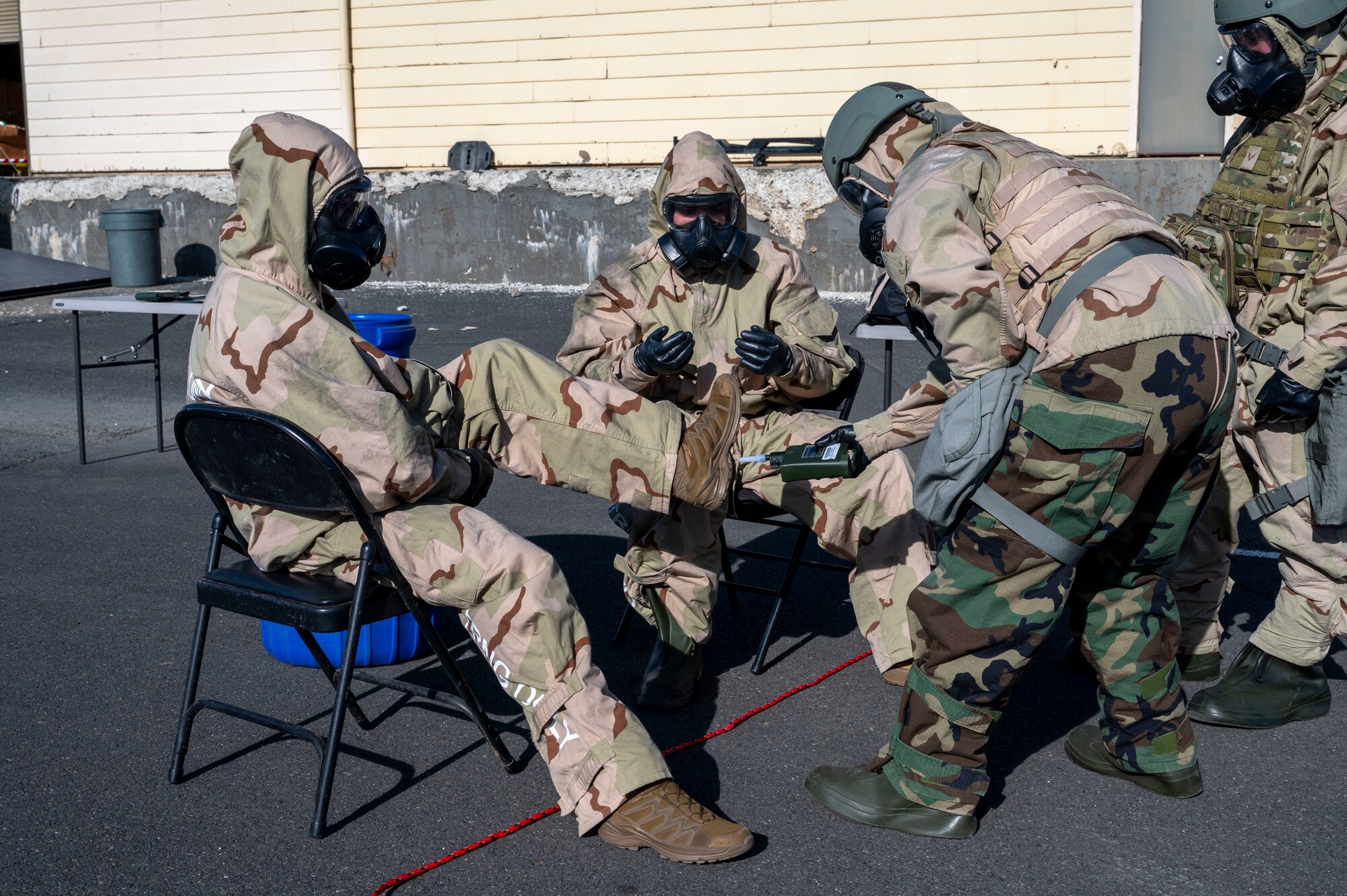 U.S. Air Force Airmen assigned to the 92nd Civil Engineer Squadron test for chemicals during the decontamination process at Fairchild Air Force Base, Washington, Feb. 22, 2025. Chemical, biological, radiological, and nuclear defense specialists are essential for conducting thorough decontamination procedures, ensuring personnel and equipment are safe from hazardous materials. (U.S. Air Force photo by Airman 1st Class Samantha Thorn)
