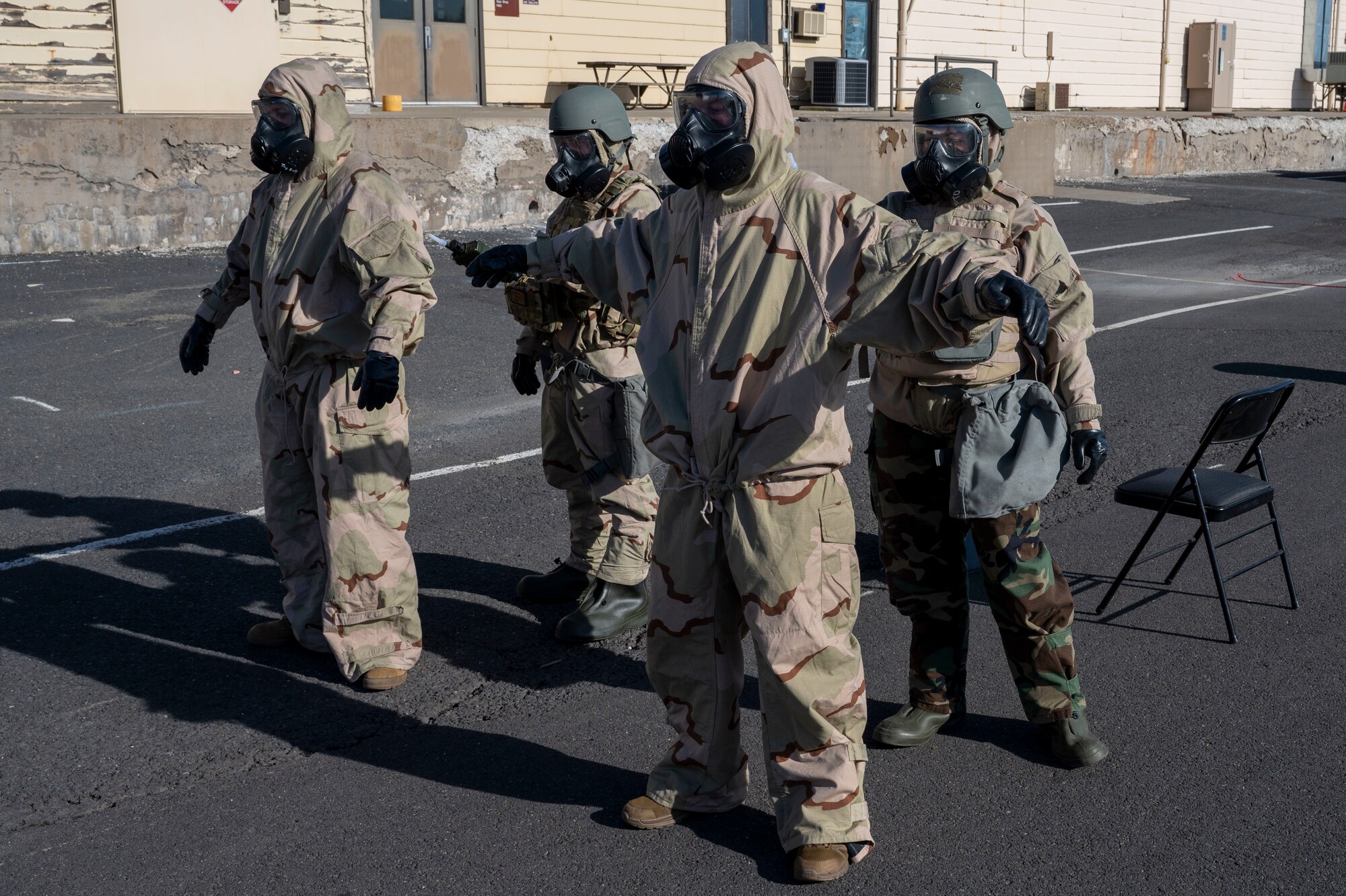 U.S. Air Force Airmen assigned to the 92nd Civil Engineer Squadron test for chemicals during the decontamination process at Fairchild Air Force Base, Washington, Feb. 22, 2025. Chemical, biological, radiological, and nuclear defense specialists are essential for conducting thorough decontamination procedures, ensuring personnel and equipment are safe from hazardous materials. (U.S. Air Force photo by Airman 1st Class Samantha Thorn)