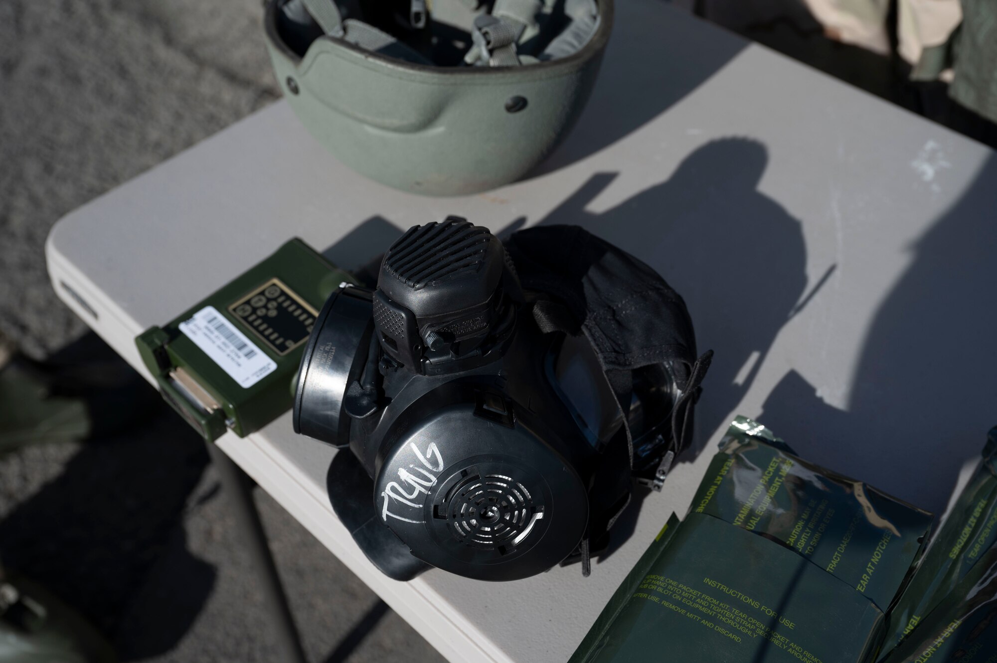 U.S. Air Force Airmen assigned to the 92nd Civil Engineer Squadron showcase a gas mask used to provide protection against chemical, biological, radiological, and nuclear attacks during an exercise at Fairchild Air Force Base, Washington, Feb. 22, 2025. Airmen demonstrate proficiency in CBRN defense by expertly handling and explaining the purpose of each tool and piece of equipment used in identifying, monitoring, and mitigating chemical and biological threats. (U.S. Air Force photo by Airman 1st Class Samantha Thorn)