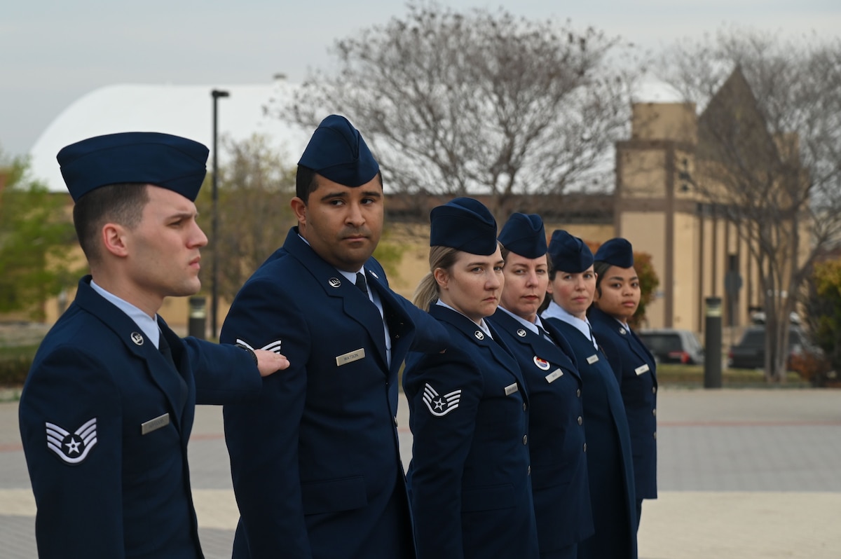 Members assigned to the 17th Force Support Squadron participate in an Open Ranks Inspection as part of a wing-wide Standards and Readiness Review outside the Norma Brown headquarters building, Goodfellow Air Force Base, Texas, March 26, 2025. Members from across the 17th Training Wing participated in Standards and Readiness Review to ensure military standards and customs and courtesies are being upheld. (U.S. Air Force photo by Airman 1st Class James Salellas)
