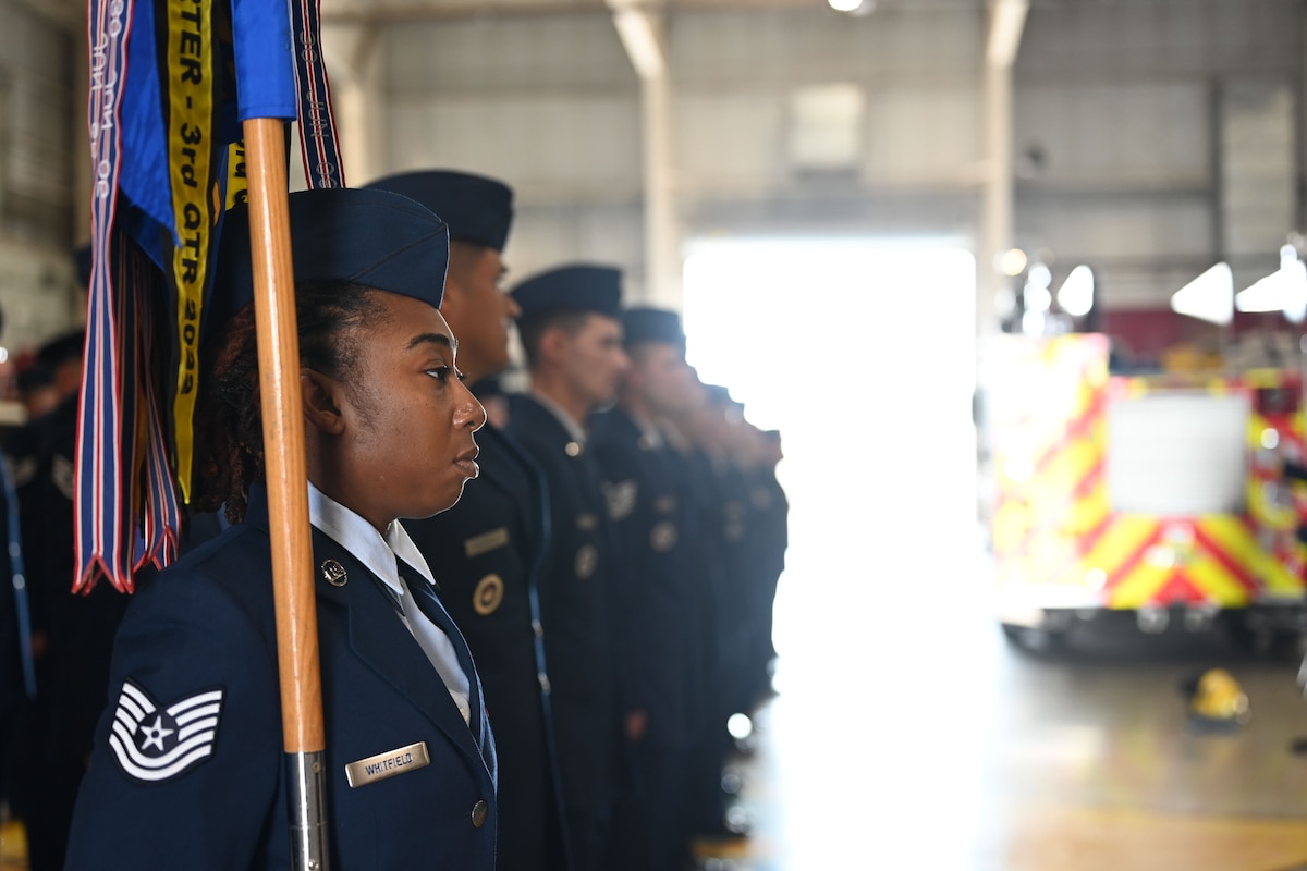 U.S. Air Force Tech. Sgt. Kasie Whitfield, 312th Training Squadron military training leader, holds the guidon during the Standard and Readiness Review at the Louis F. Garland Department of Defense Fire Academy, Goodfellow Air Force Base, Texas, March 26, 2025. At the squadron level, the SRR provides a valuable opportunity for leaders to engage directly with their teams, hold them accountable, and instill a culture of professionalism. (Air Force Photo by Senior Airman Evelyn J. D’Errico)