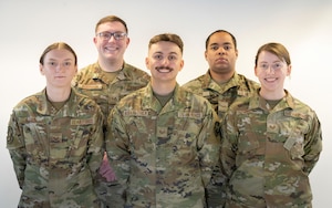 Five Airman pose for a photo