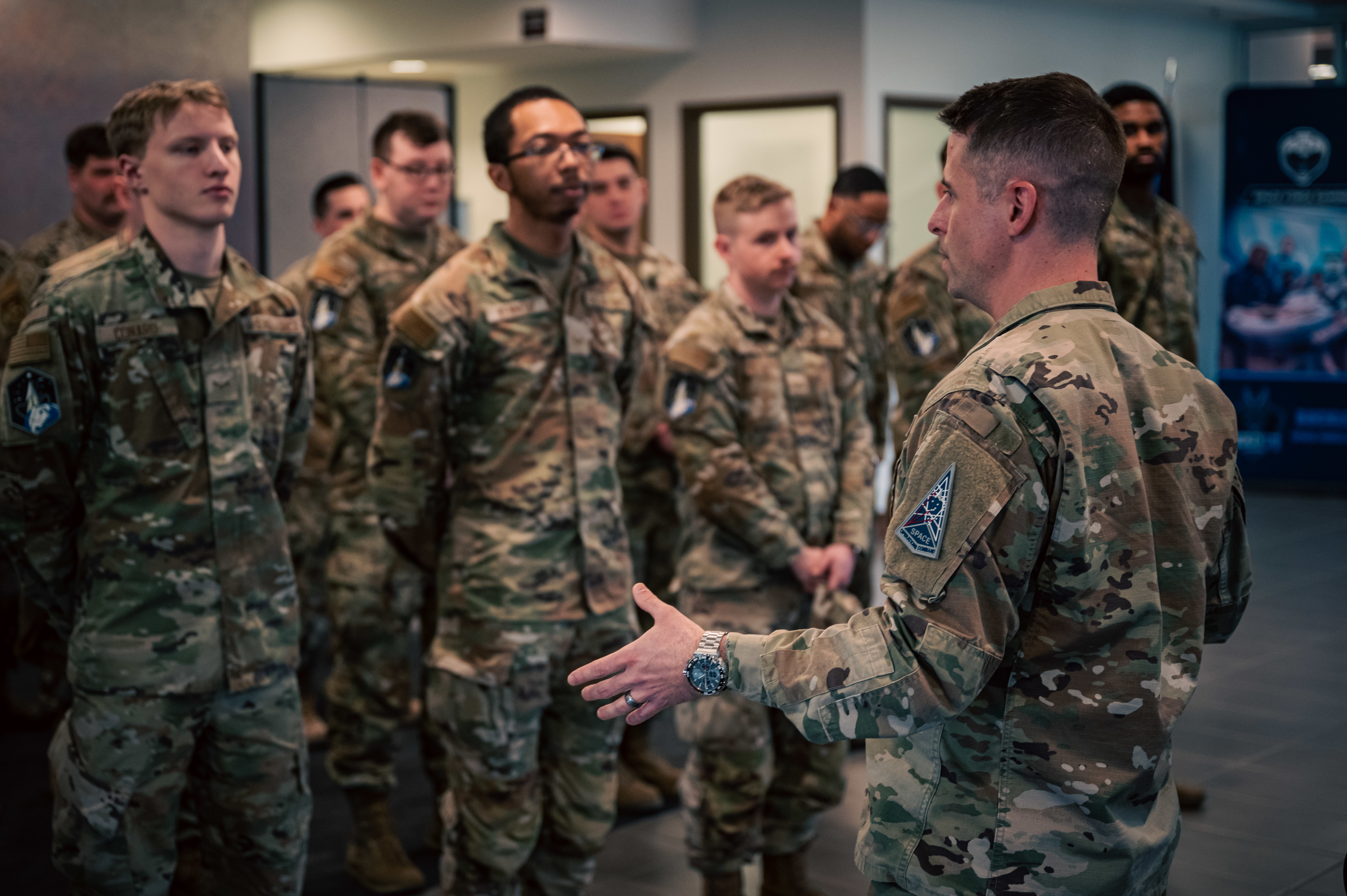 U.S. Air Force Master Sgt. Ryan McCammon, Space Base Delta 2, First Sergeant, addresses service members during a Standards and Readiness Review uniform inspection at Buckley Space Force Base, Colorado, March 21, 2025. Following the inspection, the First Sergeant provided feedback and reinforced the importance of maintaining military appearance standards. (U.S. Space Force photo by Senior Airman Joshua Hollis)