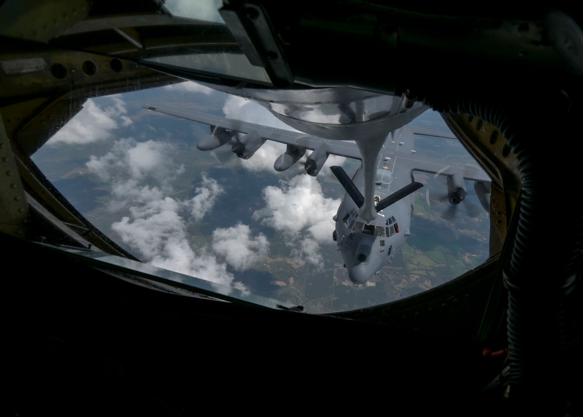 A military aircraft is aerial refueled by another military aircraft.