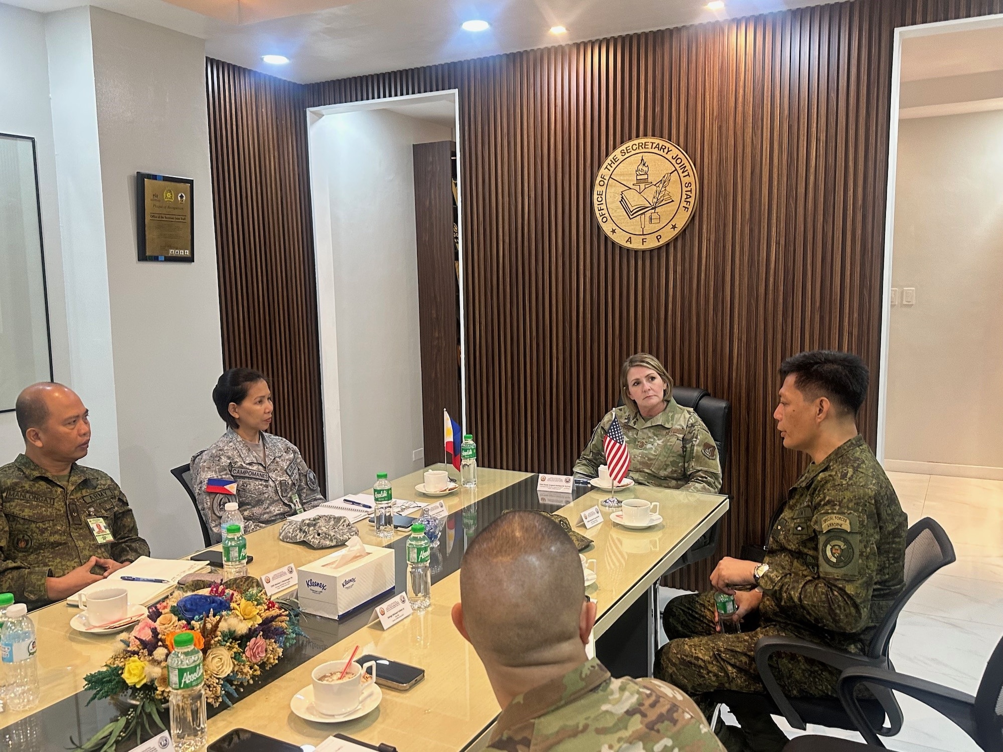 five people sit around a table