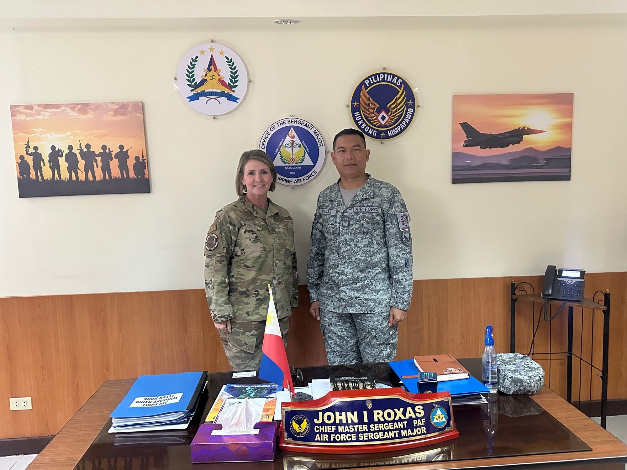 Two people stand behind a desk