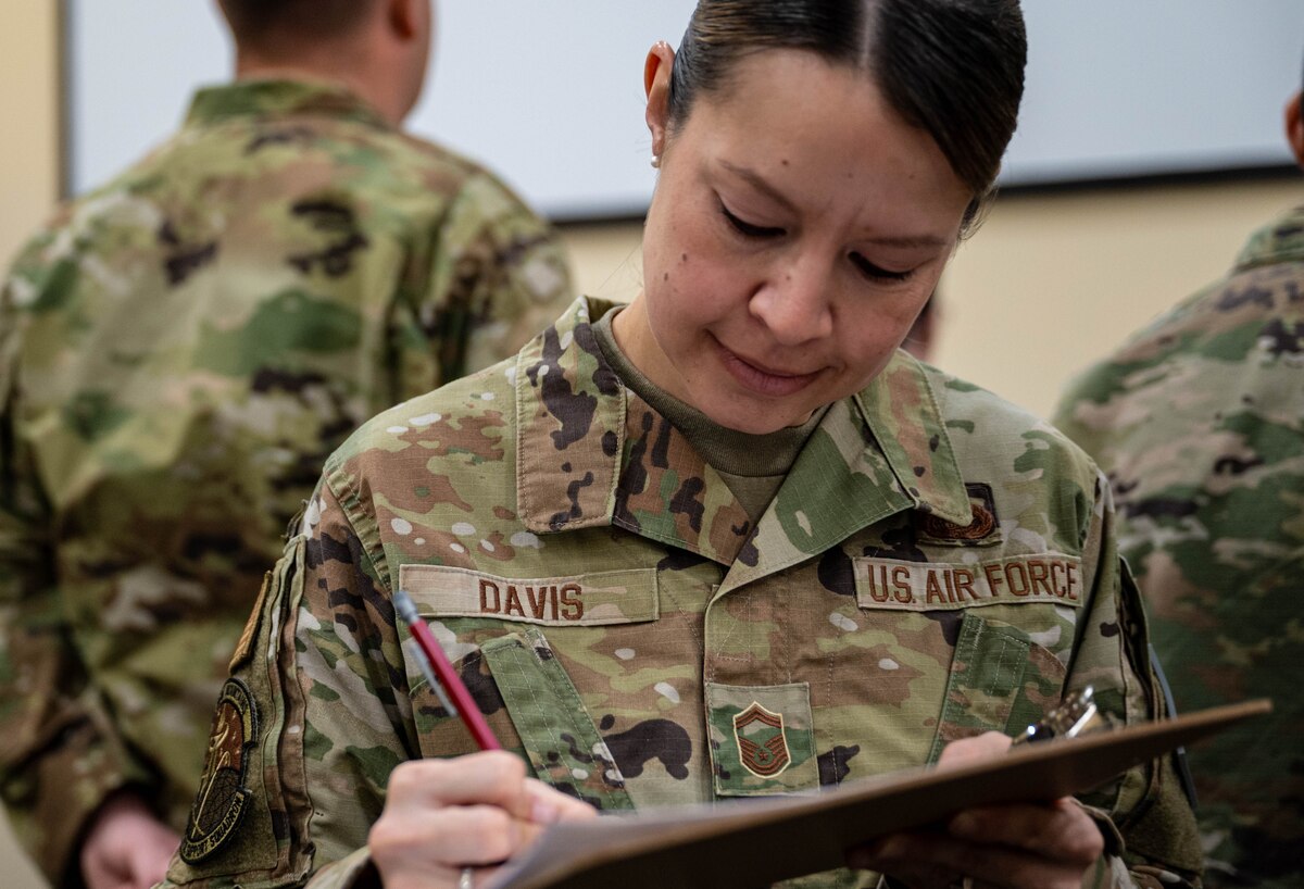 a woman writes on a clipboard