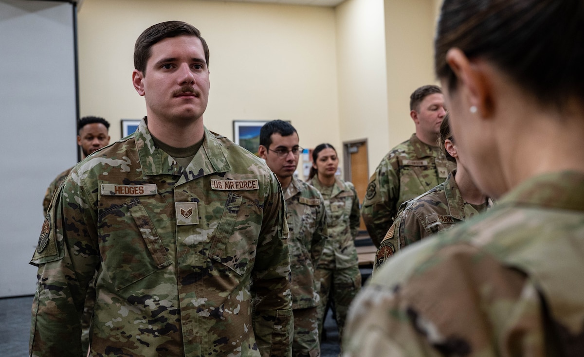 a service member stands in formation while being inspected