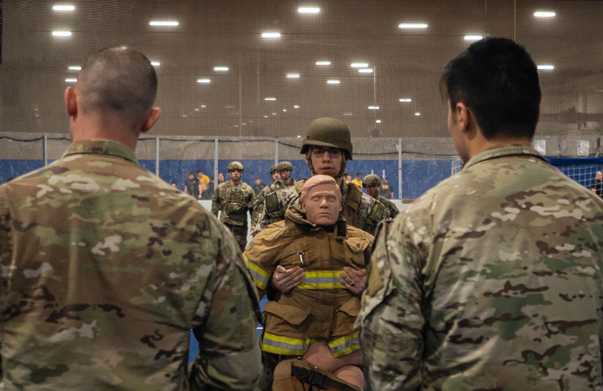 A service member is observed performing a buddy drag during the physical fitness portion of Savage Raider Team tryouts at the Offutt Field House gym March 4, 2025. Potential recruits had to pass a physical fitness assessment to advance in the tryouts. (U.S. Air Force photo by Daniel Martinez)